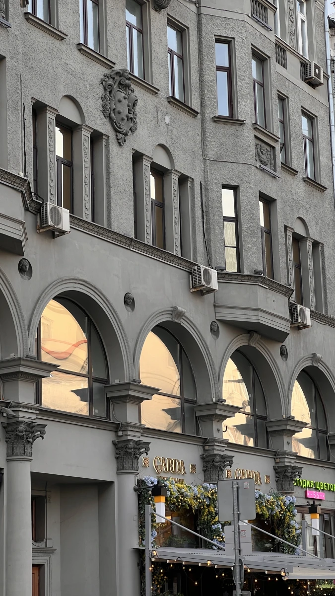 Монументальная арка здания со старинными фонарями внутри