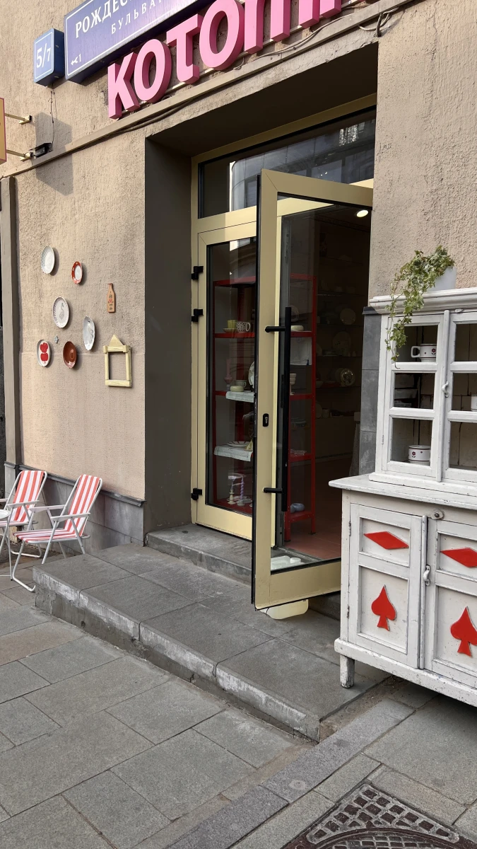 Веранда с полосатыми стульями и тарелками на стене