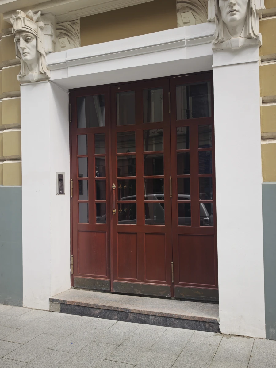 Коричневая деревянная дверь на Плотников переулке.